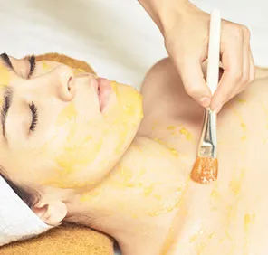 Woman getting a full body peel at a cosmetic skin care clinic.
