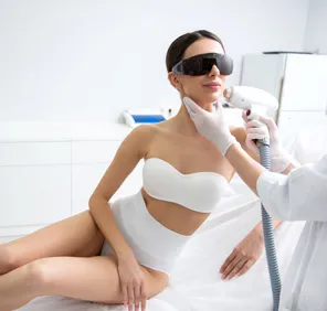 Woman getting full face laser treatment for unwanted facial hair.