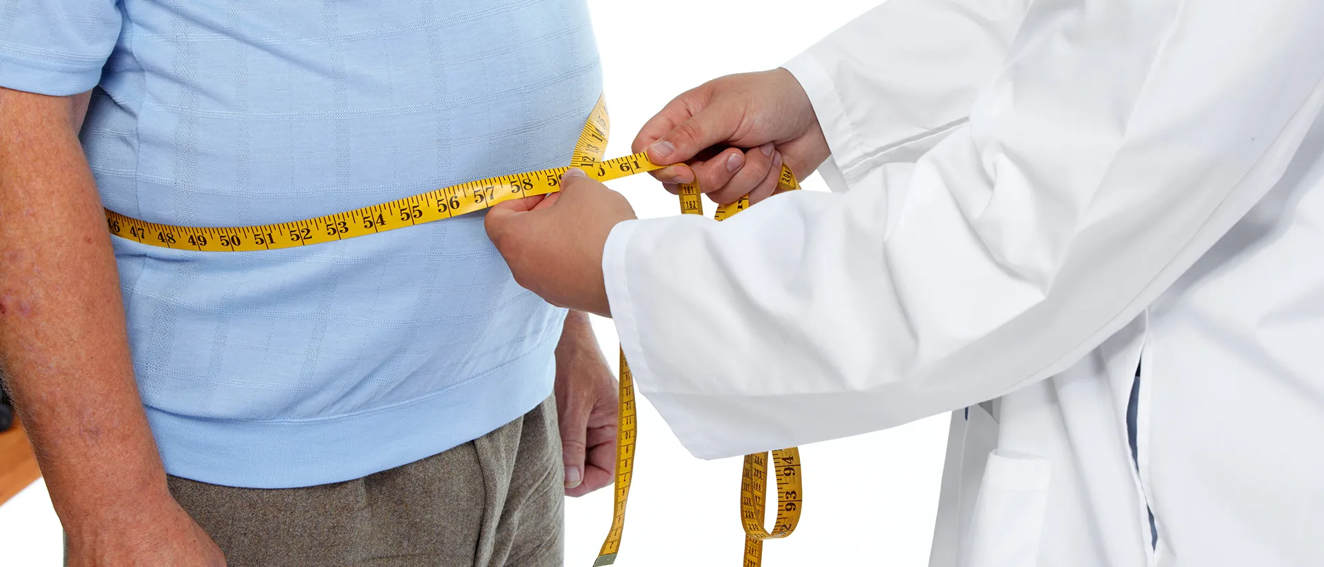 Big fat tummy of an obese man being measured by a doctor.