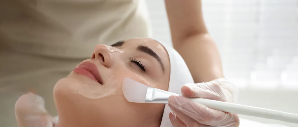 Woman getting a peeling treatment at a cosmetic skin care clinic.