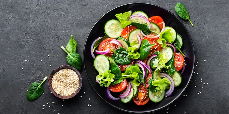 Fresh tomato, onion, spinach, lettuce and cucumber salad for weight loss.