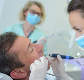 Man getting a root canal treatment at a dental care clinic.
