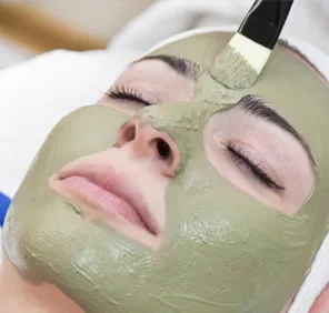 Woman's face covered with a brightening facial mask.