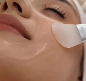 Woman getting a face peel at a cosmetic skin care clinic.
