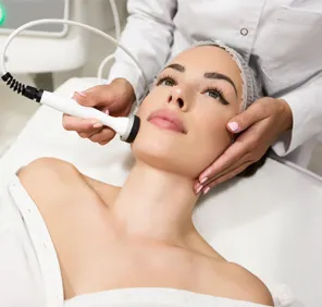 Woman getting laser treatment for facial hair on cheeks.
