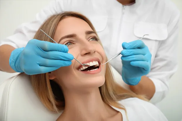 Woman getting her teeth examined by a dentist for dental implants.
