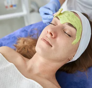 Woman getting a natural facial at a salon.