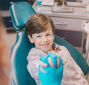 A happy child at a dental care clinic.
