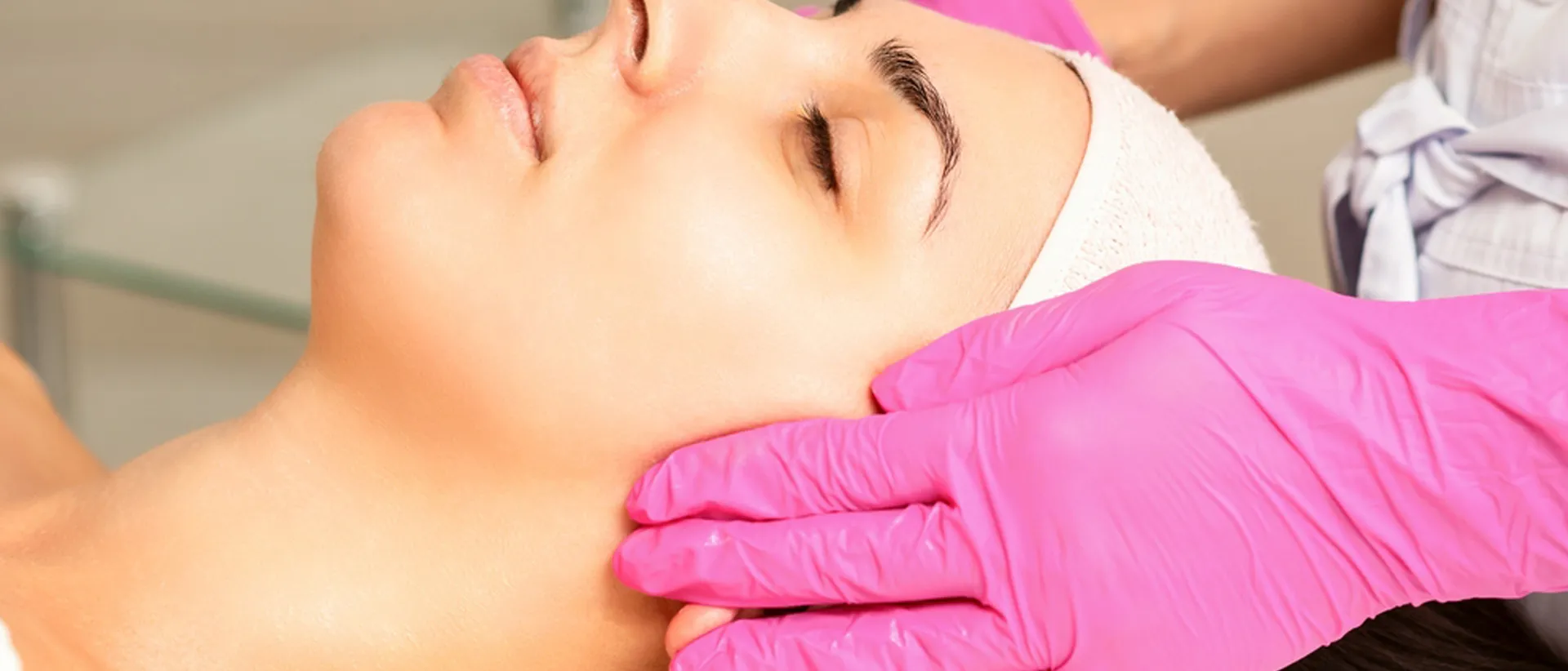 Fair woman face undergoing peels treatment at cosmetic skin care clinic.

