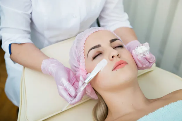 Woman getting an advanced facial at a salon.
