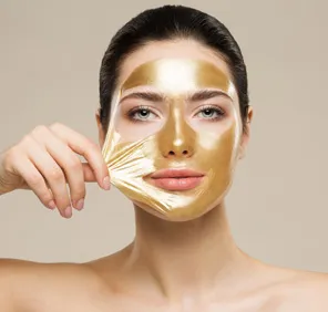 Glow clean up at parlour - woman with face pack on her face for glowing skin.
