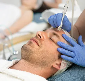 Man getting Microdermabrasion at a skin and hair clinic.